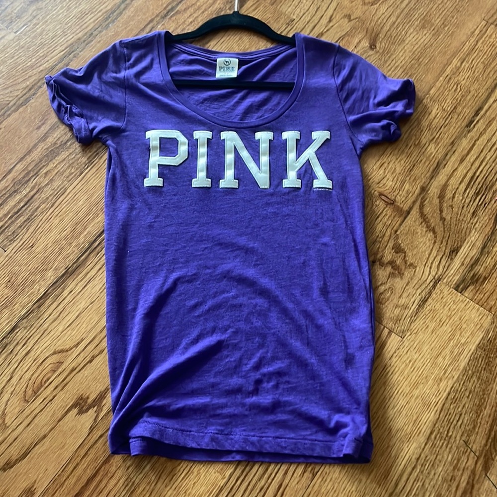 Brand is PINK. Size is a small. Color is purple with “PINK” written in white.